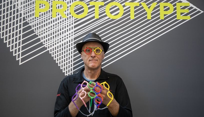 James Hermsen holding six pairs of colorful glasses