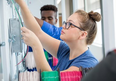 Female student working on electrical wiring