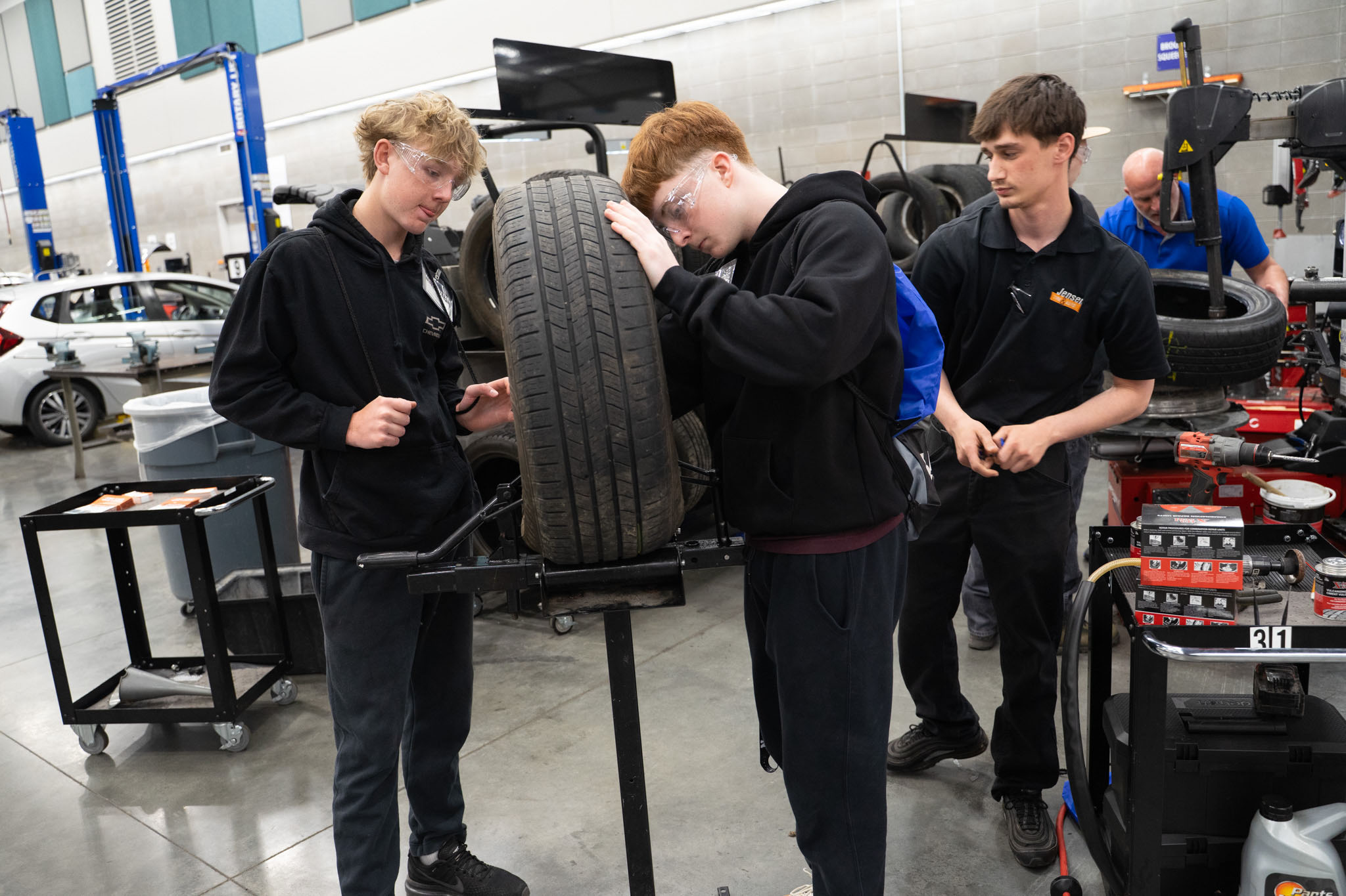 Two students plugging a tire