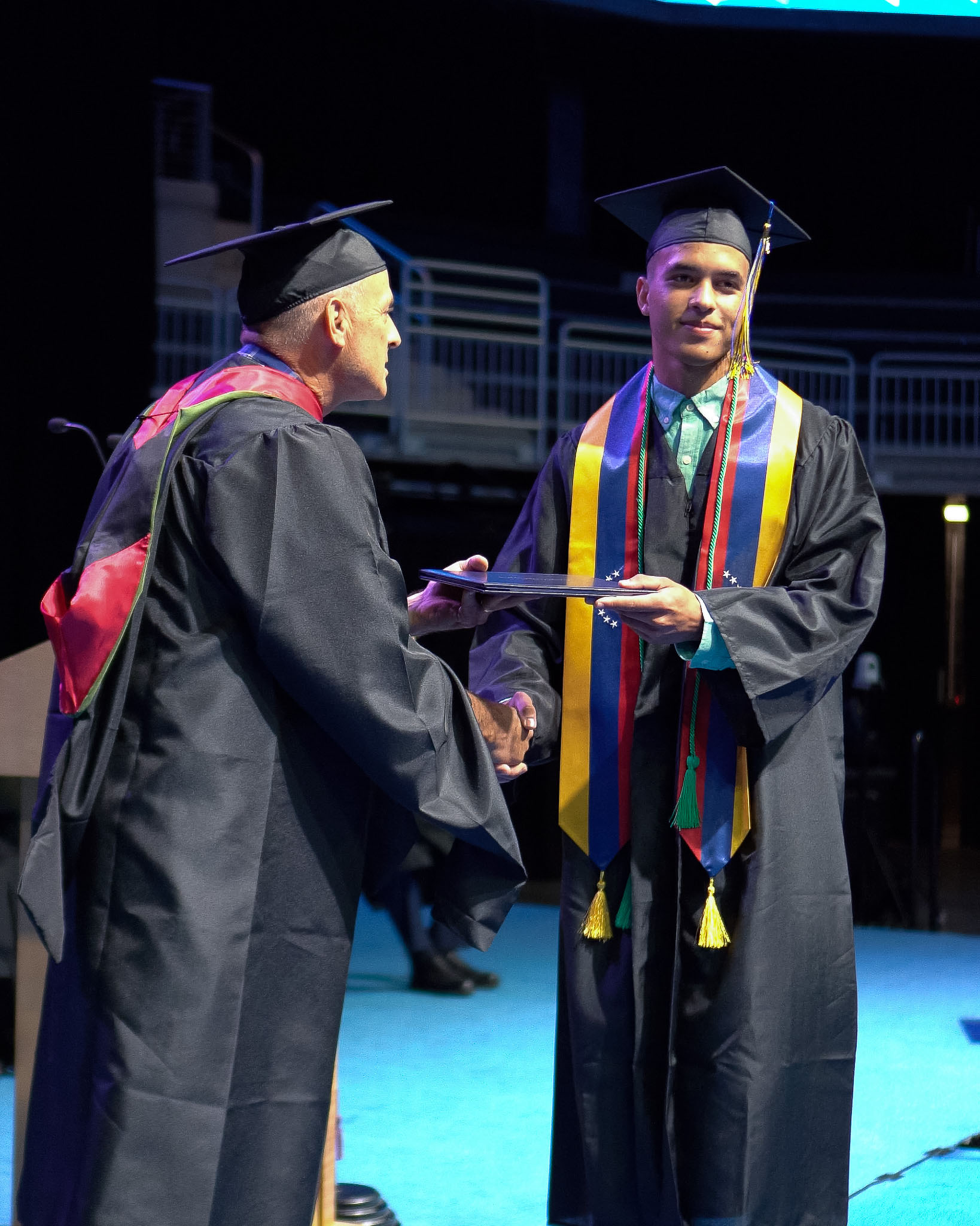 Male student accepting degree on stage