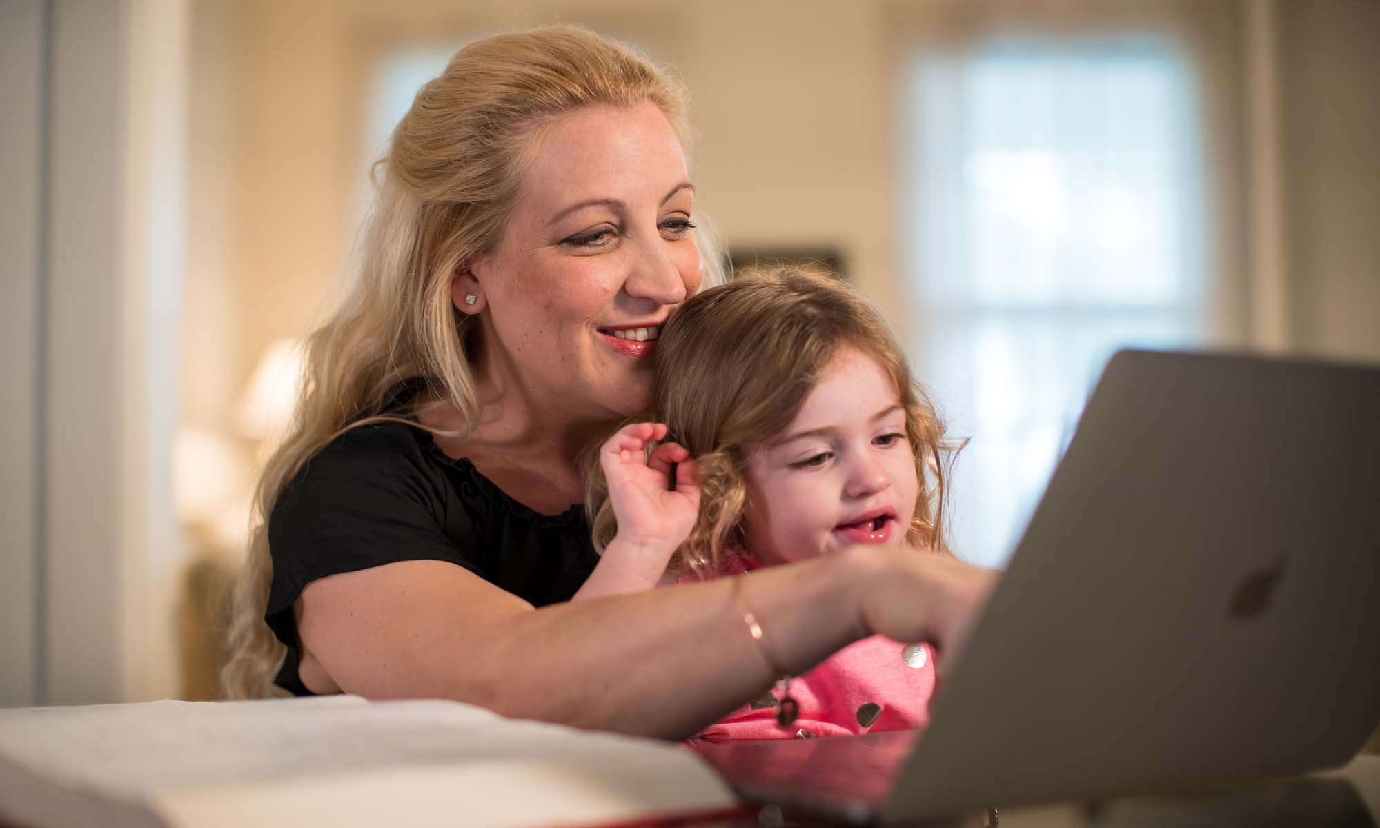 Mother working at table with her child