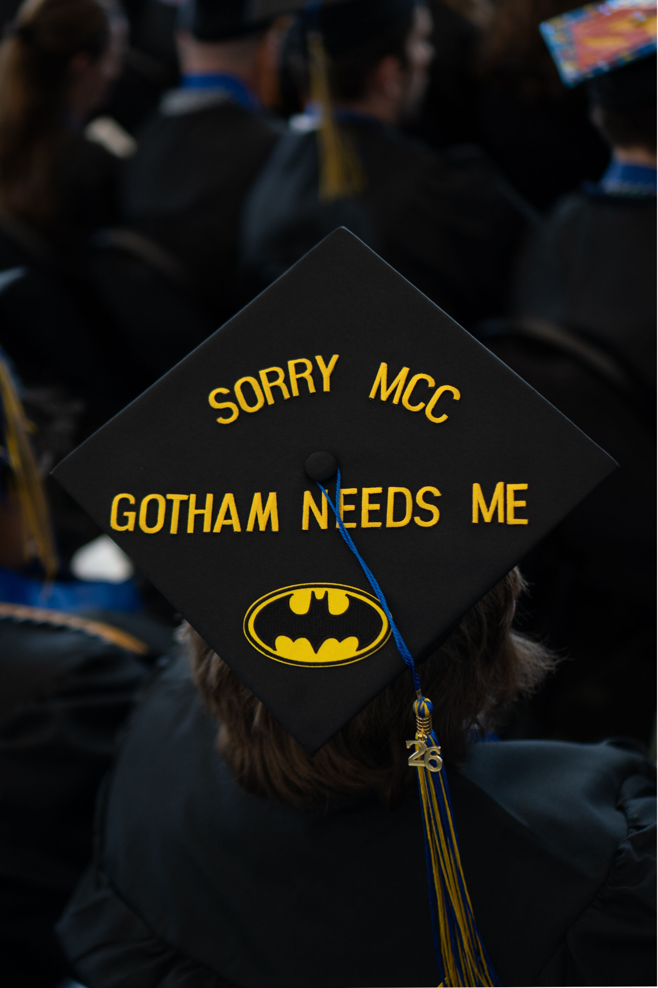 Student wearing batman themed graduation cap