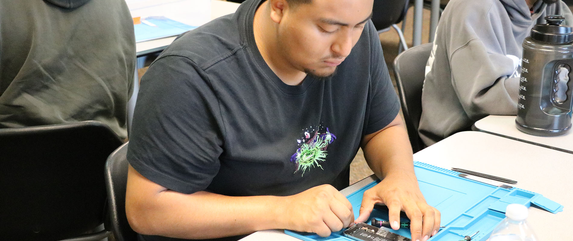 Student repairing a smart phone