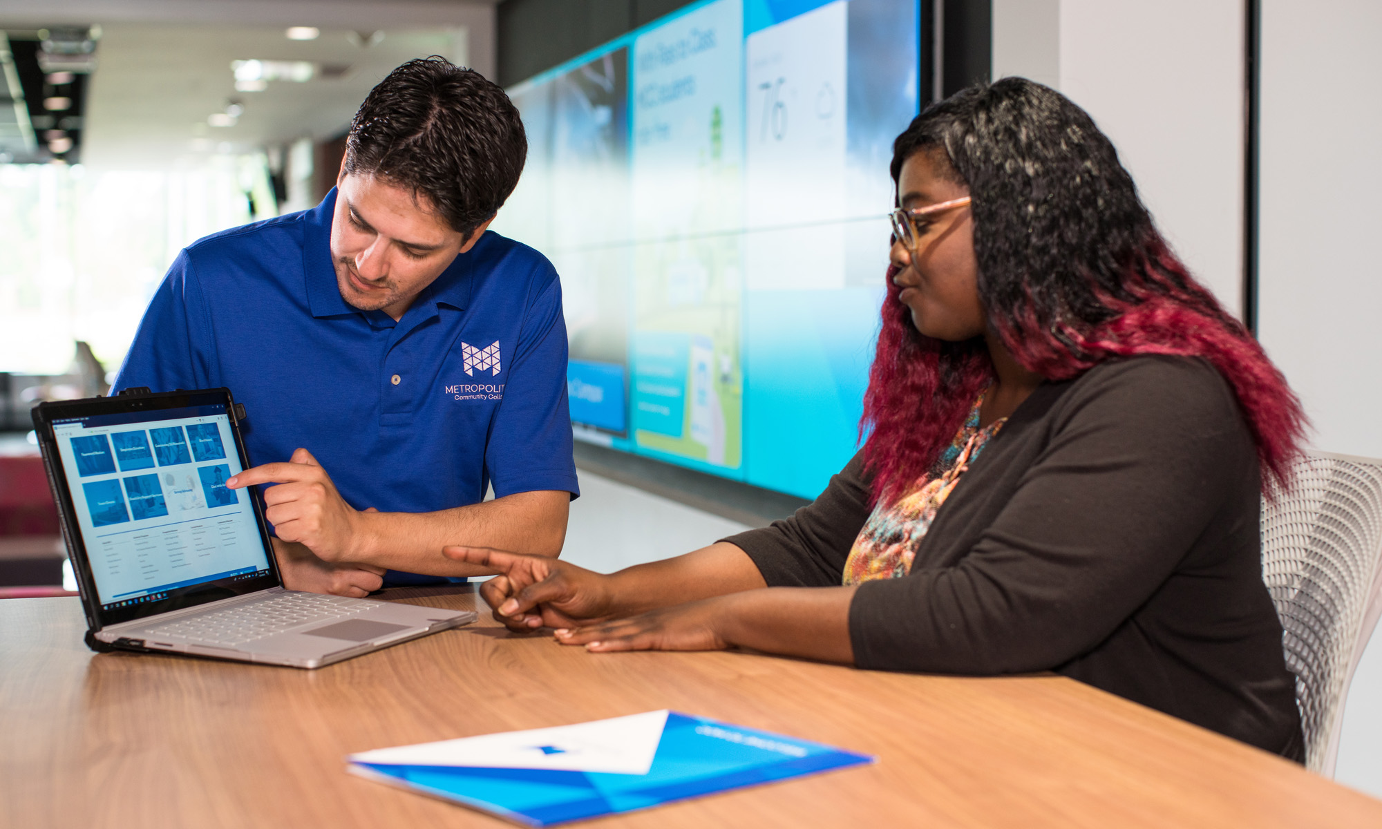 Student working with advisor on laptop