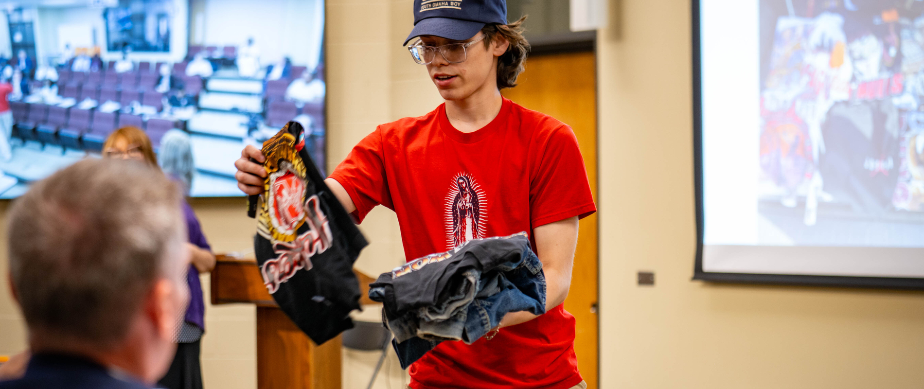 Carmine Cantania shares fashion designs from his startup Vintage Worldwide with attendees at the MCC FastTrac student pitch competition.