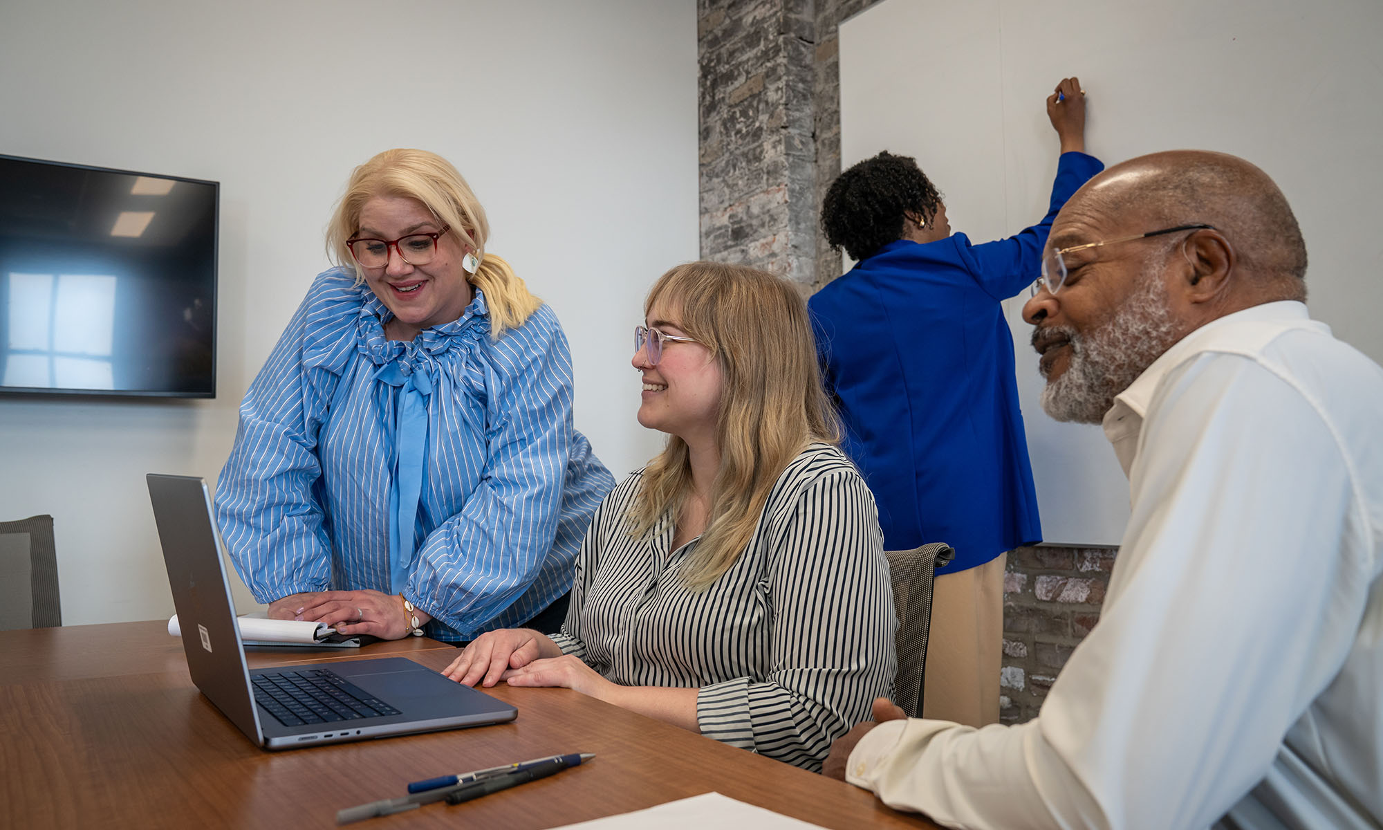 Student getting help on computer.