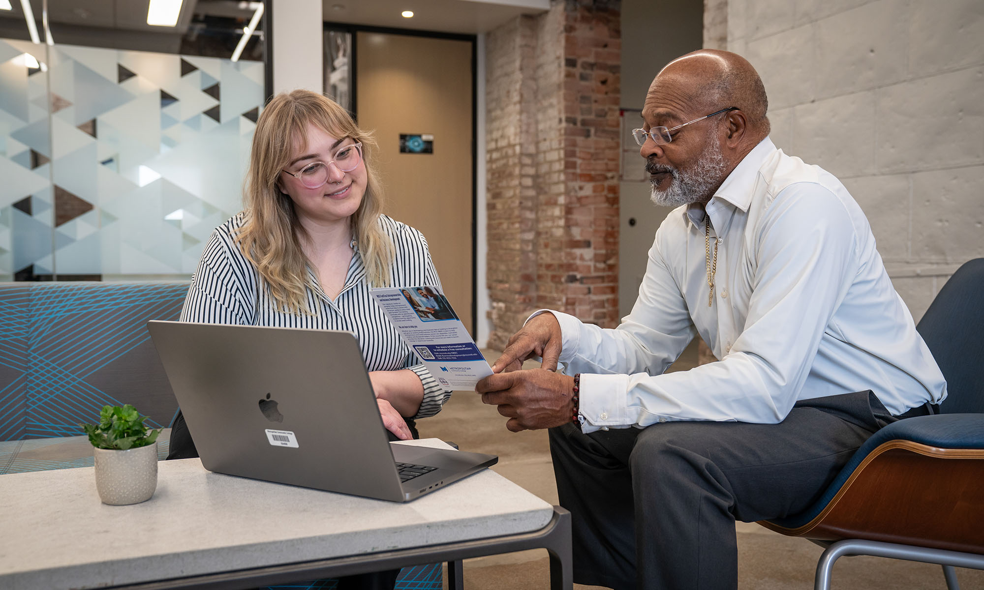 Student in Digital Express smiling on laptop.