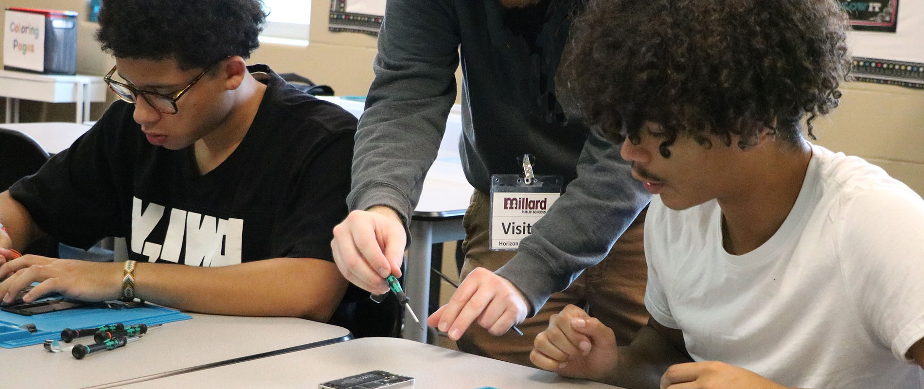 Group of students repairing a smart phone