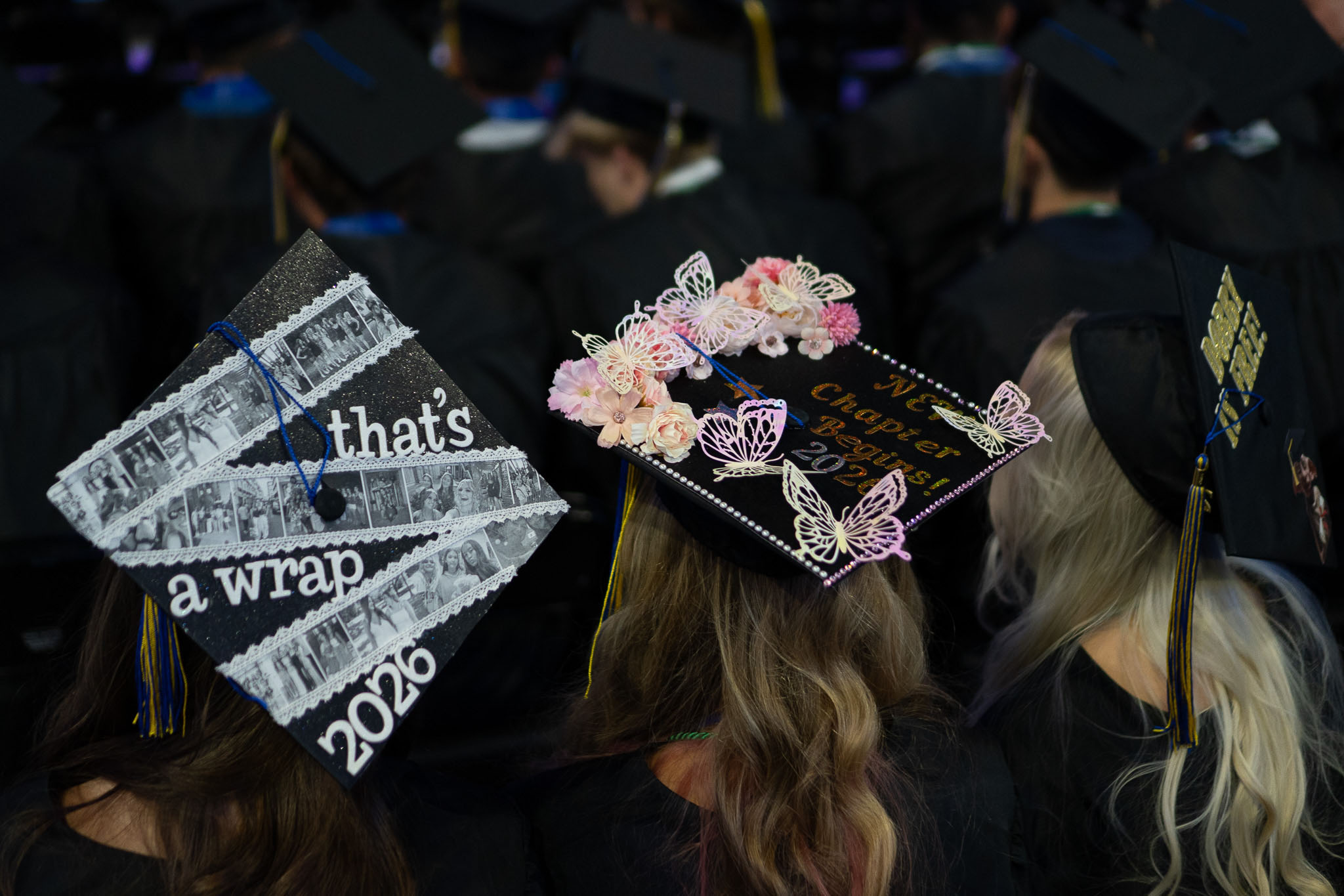 Photo of group of students wearing decorated graduation caps