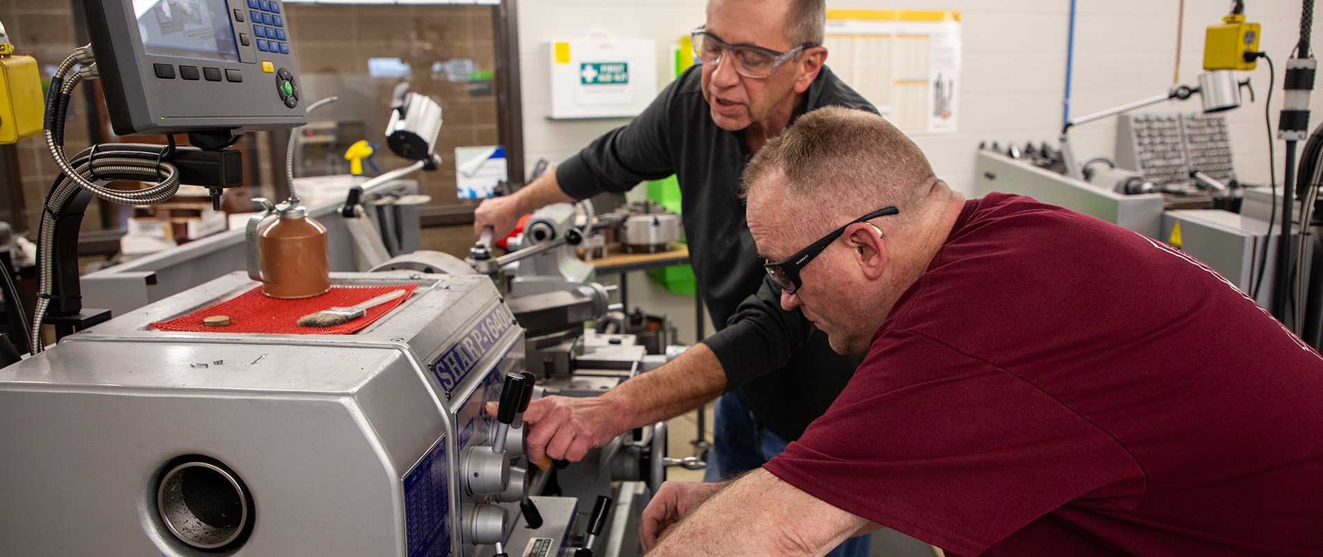 Talkington and instructor John Banark working in the machining lab on the South Omaha Campus